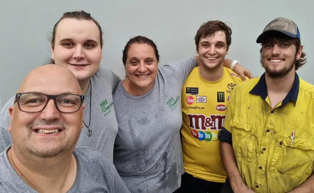 Members of a family owned and operated cleaning business smiling happily at the camera