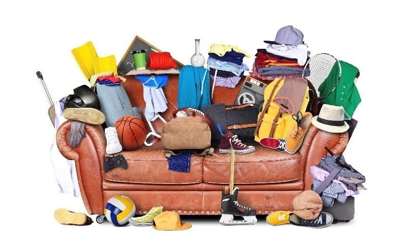 A sofa cluttered and covered in stuff