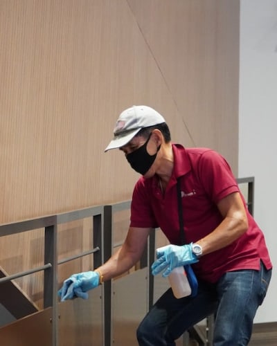 Professional cleaner cleaning the stairs of a commercial building