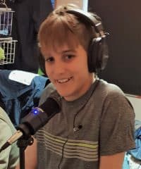 boy wearing a headset in front of a mic